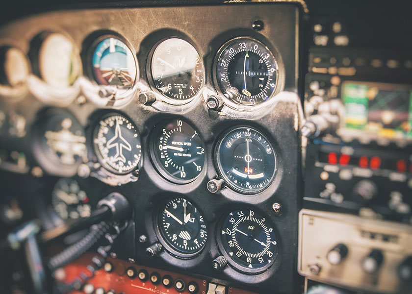 A pilot adjusting the flight path, symbolizing how financial plans require ongoing course corrections to stay on track.